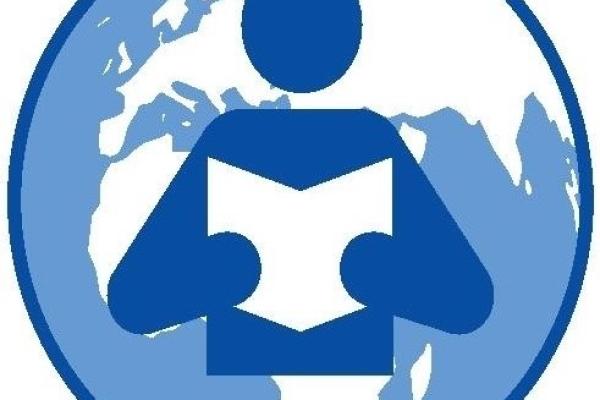 image of a person holding a book, against the map of the world